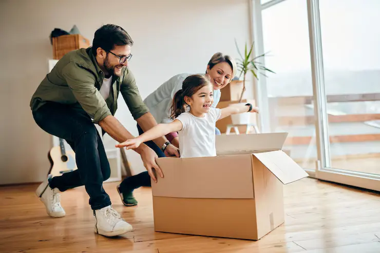 Happy family unpacking boxes in a new modern apartment in Giga Downtown residential community, Islamabad