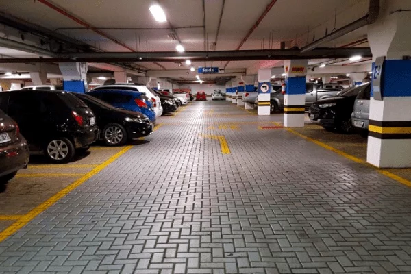 Secure and spacious underground parking facility at Goldcrest Views with organized lanes and ample lighting.